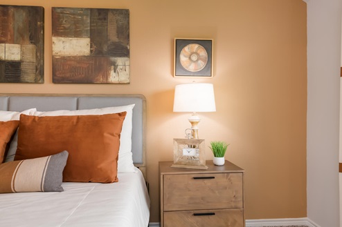Foxborough model home primary bedroom with king bed and accent decor.