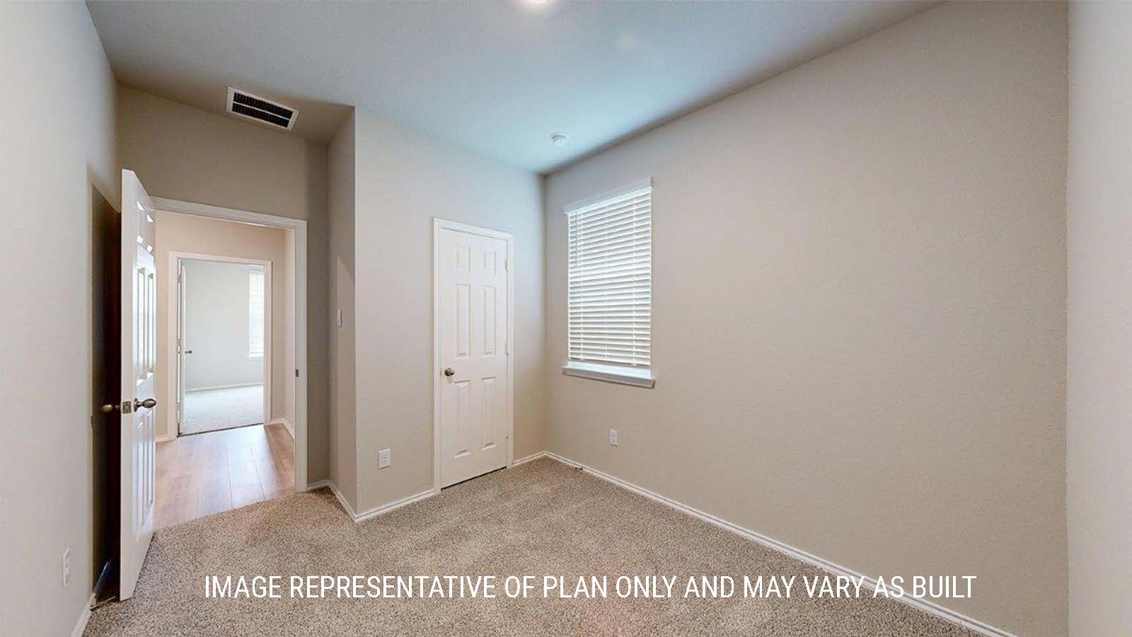 1402 Secondary bedroom with carpet flooring and closet door.