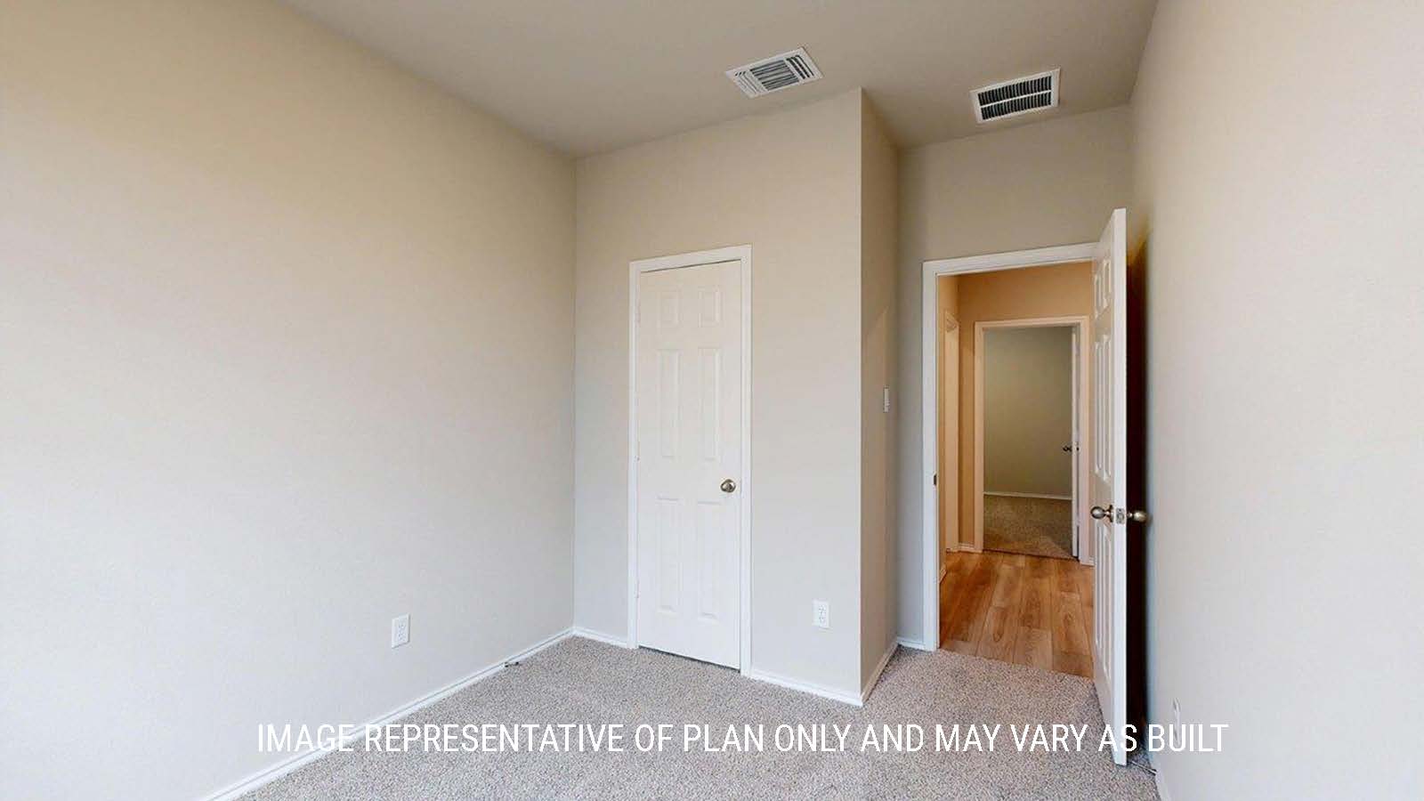 1402 Secondary bedroom with carpet flooring and closet door.