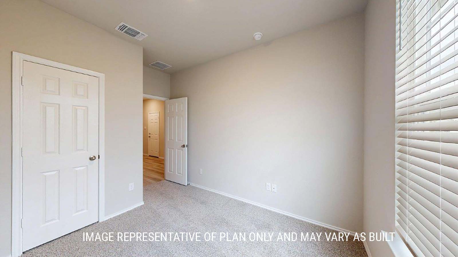 1402 Secondary bedroom with carpet flooring and closet door.