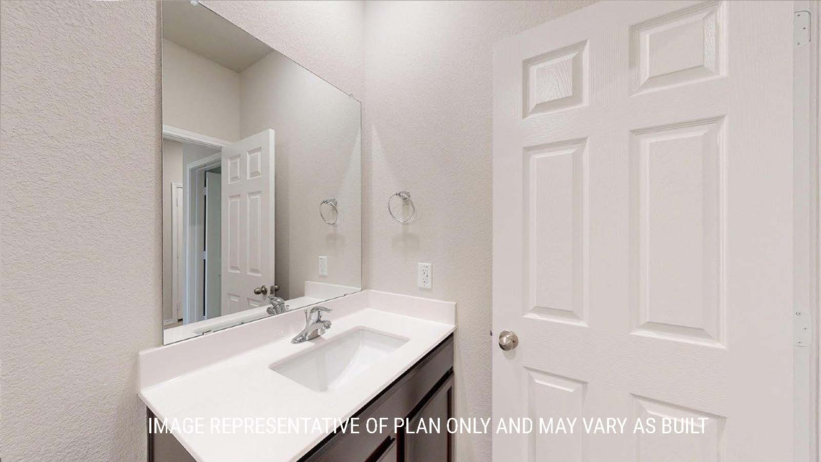 1402 Secondary bathroom with vanity sink with granite countertops and mirror.