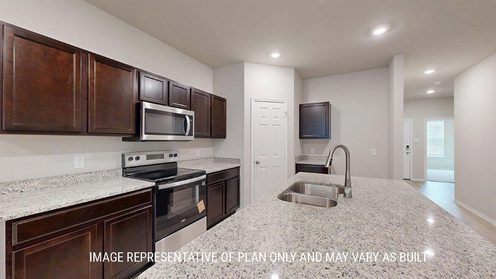 1402 Kitchen with dark cabinets and granite countertops.
