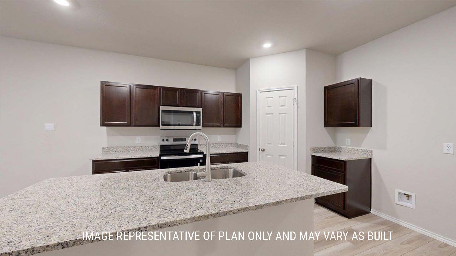 1402 Kitchen with dark cabinets and granite countertops.
