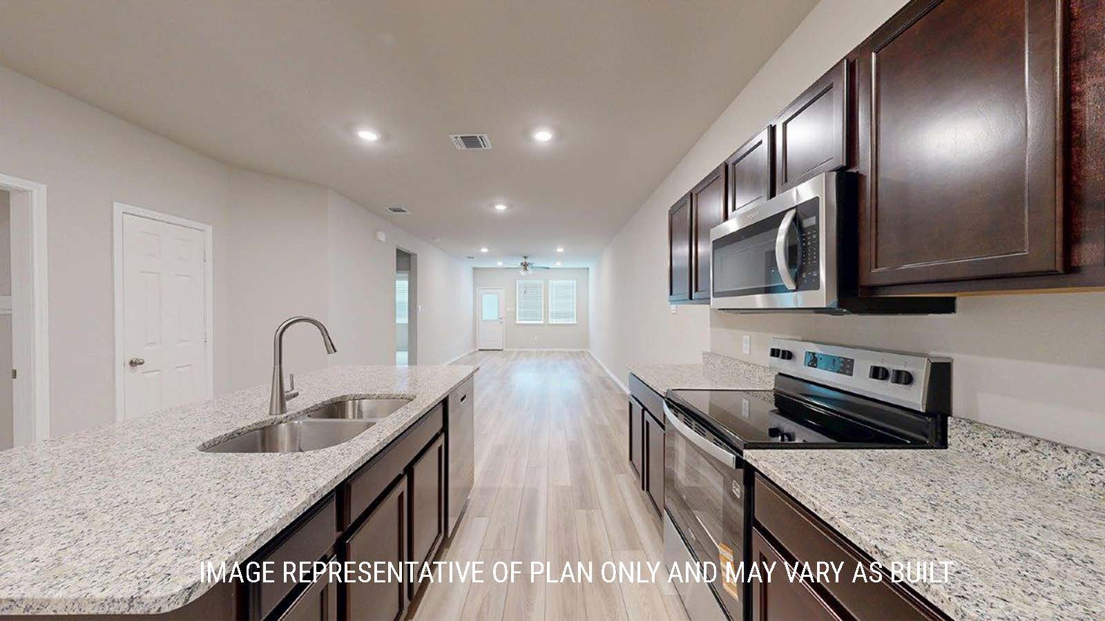 1402 Kitchen with dark cabinets and granite countertops with view of living room.