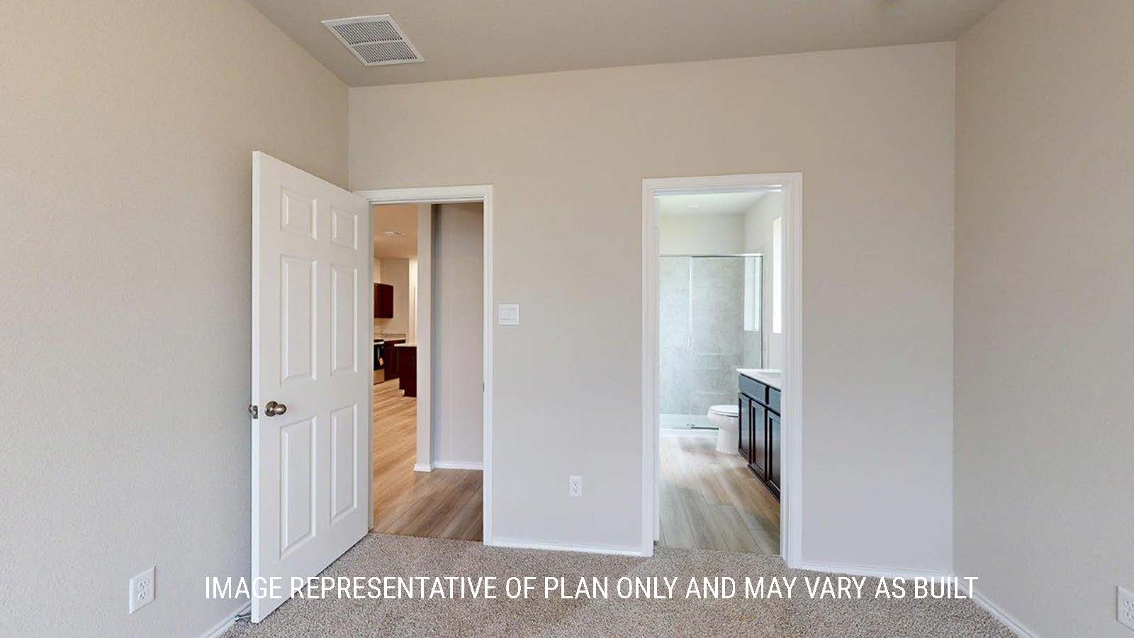 1402 Primary bedroom with carpet flooring and view of primary bathroom.