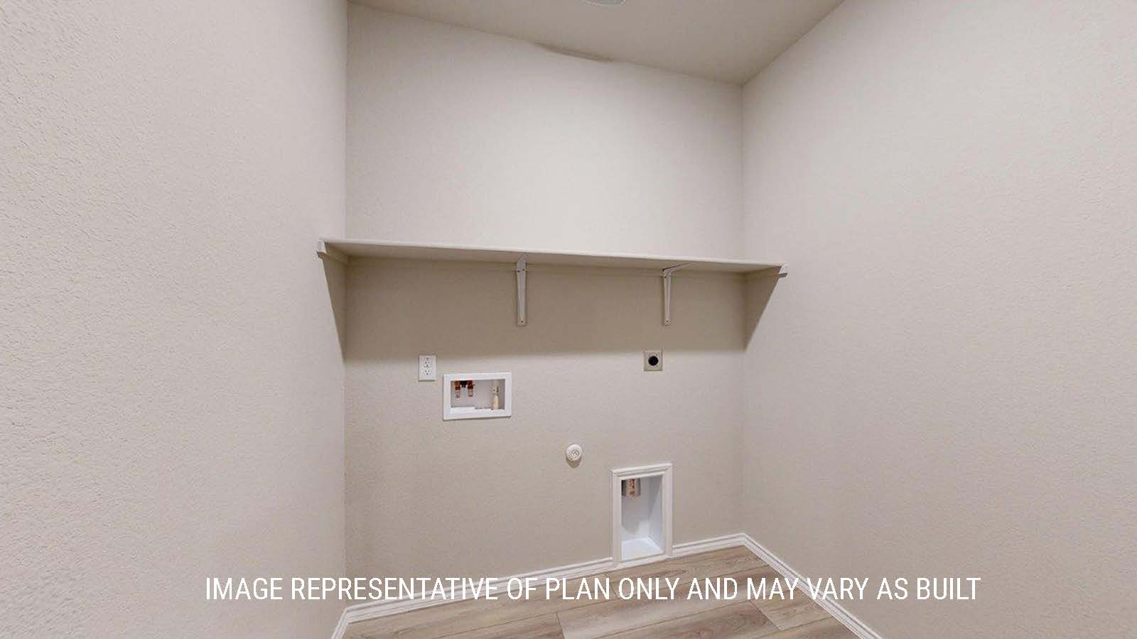 1402 Utility room with washer and dryer connections and shelving.