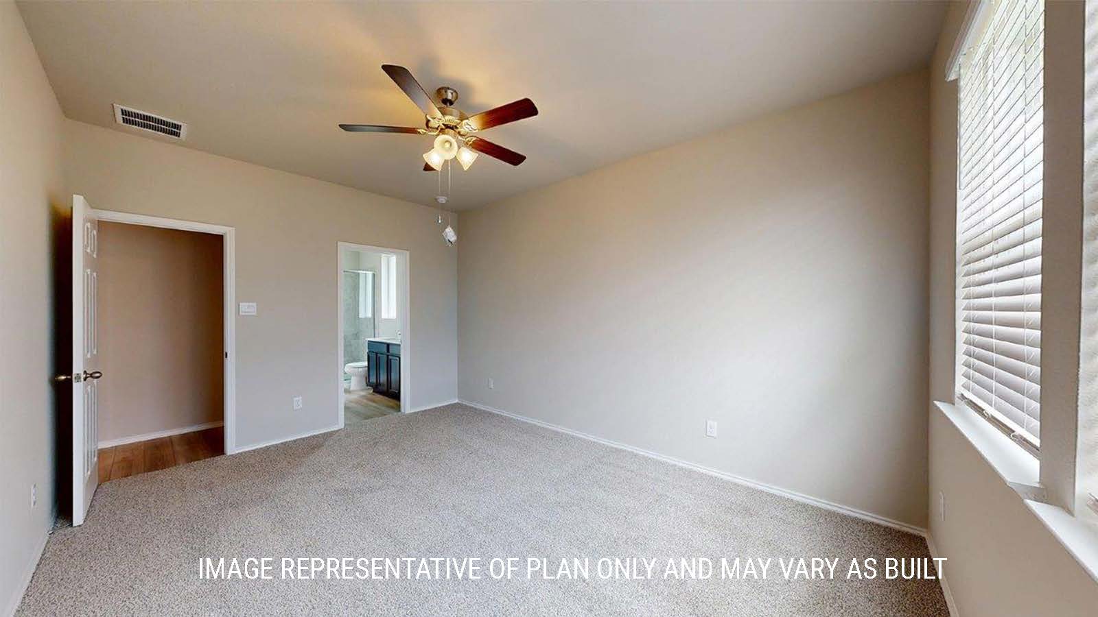 1402 Primary bedroom with carpet flooring and view of primay bathroom.