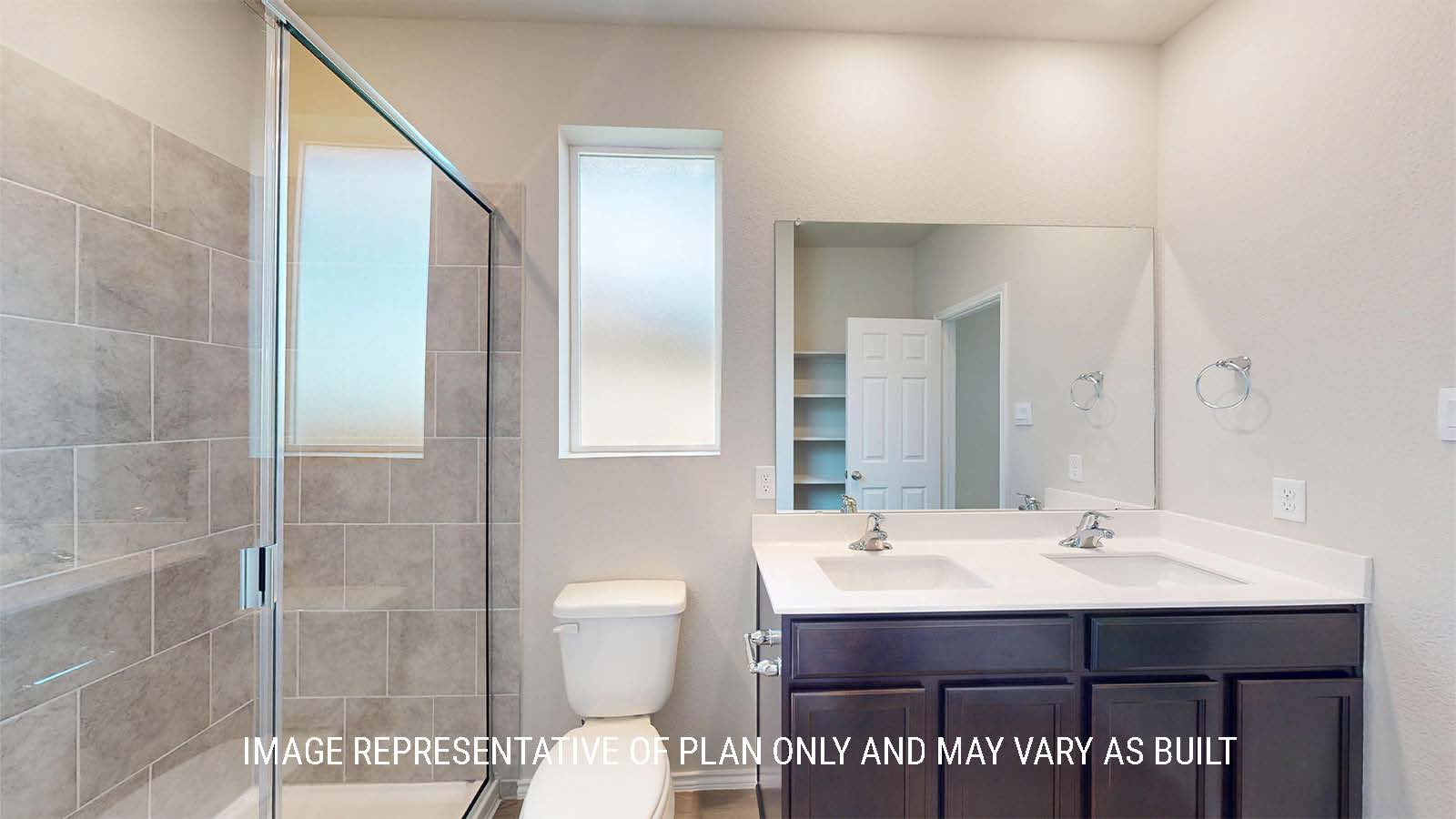 1530 Primary bathroom with duel vanity sinks and walk-in shower.