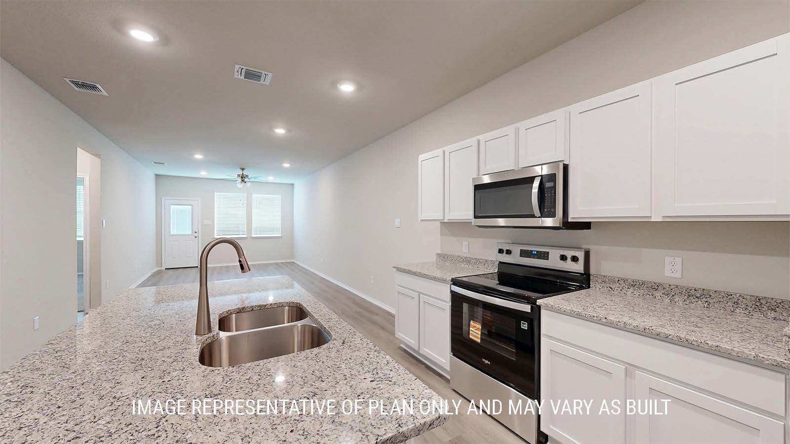 1530 Kitchen with white cabinets and granite countertops and view of living room.