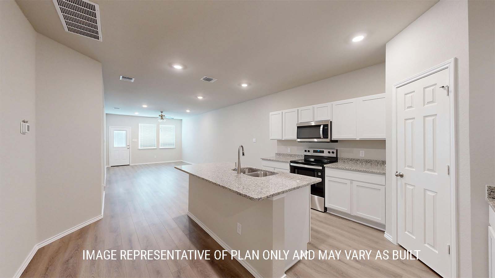1530 Kitchen with white cabinets and granite countertops and view of living room.