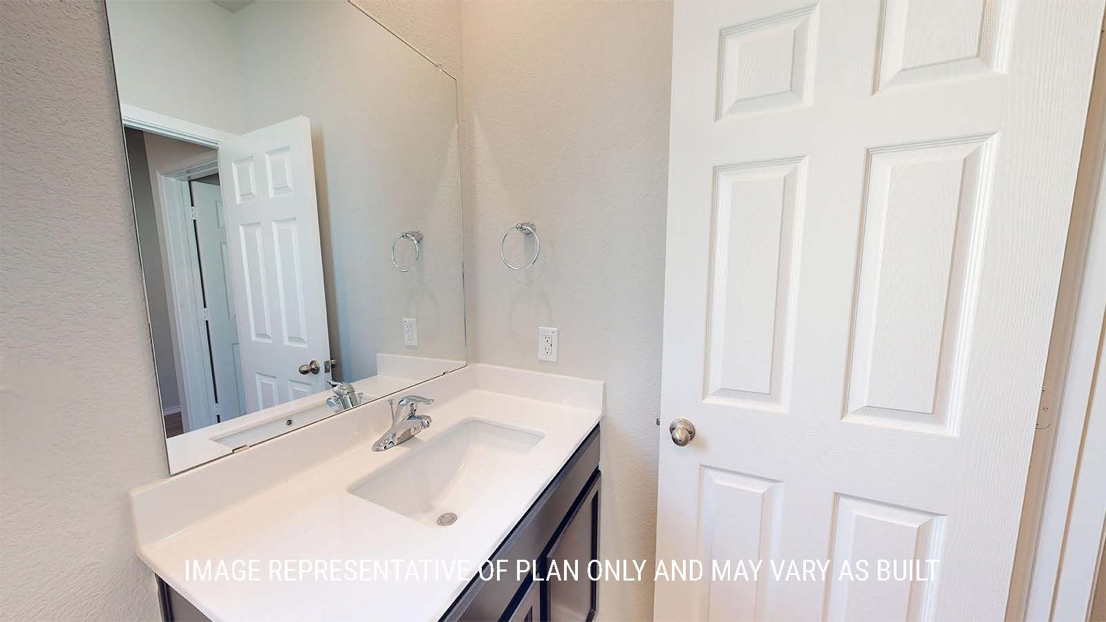 1530 Secondary bathroom with vanity sink and granite countertops and mirror.