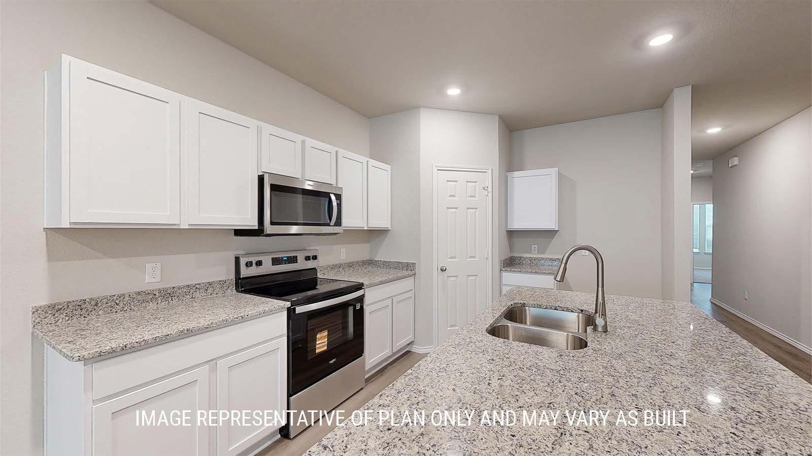 1530 Kitchen with white cabinets and granite countertops.