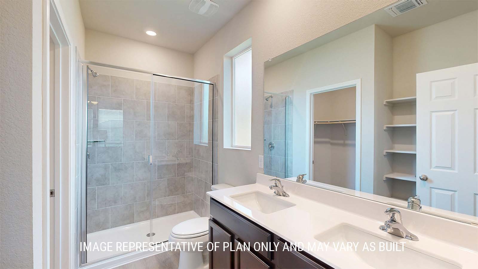 1530 Primary bathroom with duel vanity sinks and walk-in shower.