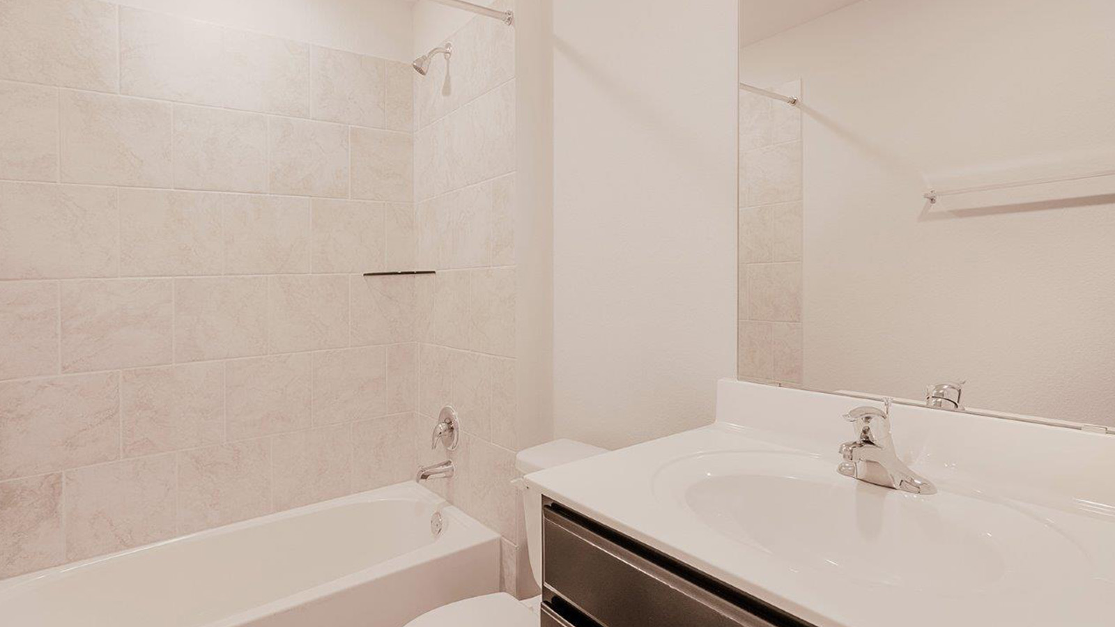 Schwertner Ranch secondary bathroom with single vanity and shower and tub combo.