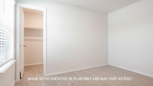 Schwertner Ranch model home secondary bedroom with carpeted flooring and closet.