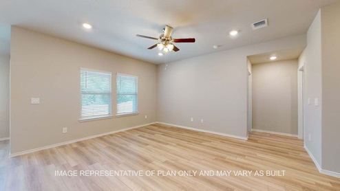 Bellvue living room with vinyl plank flooring and windows for natural lighting.