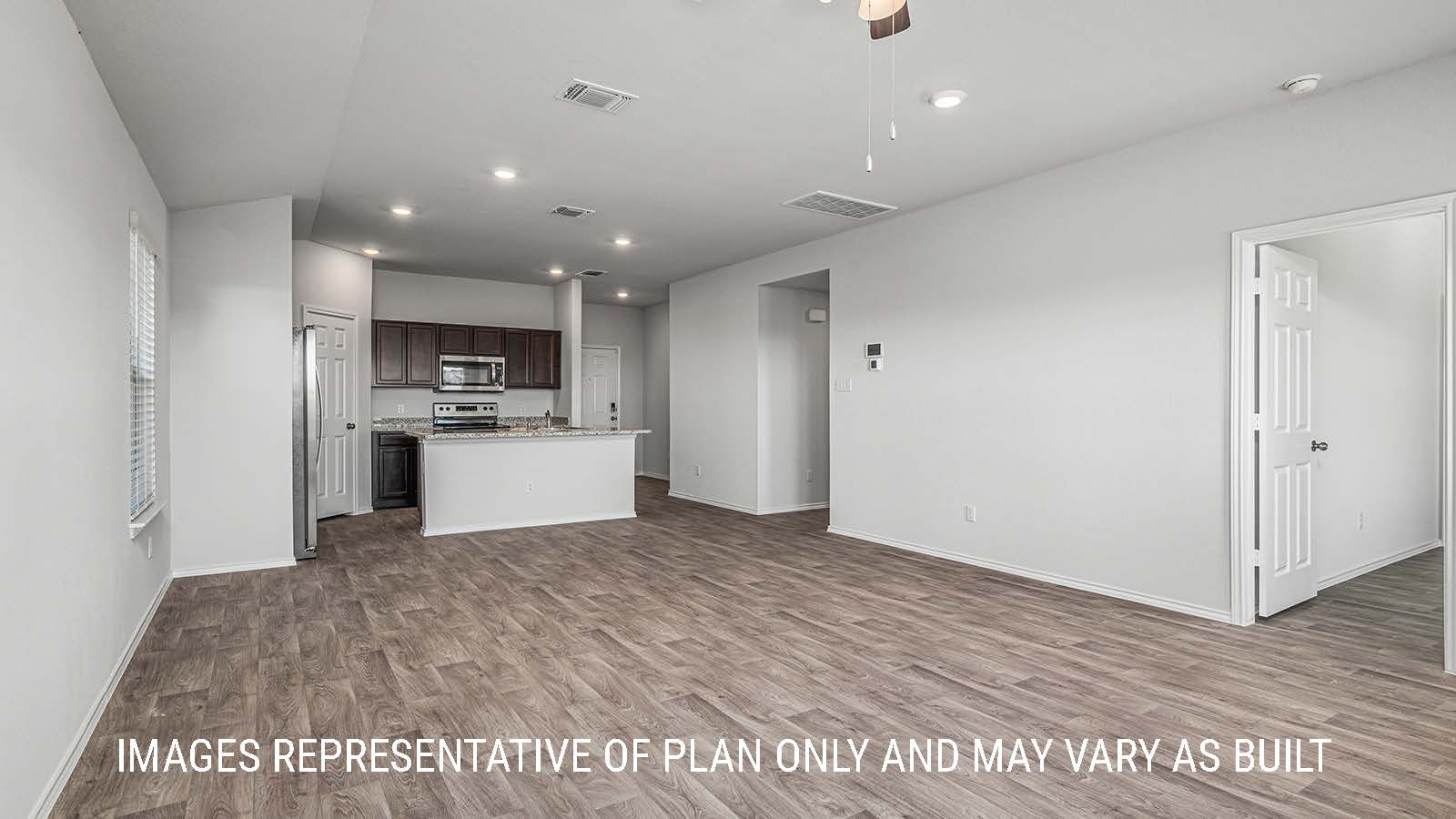 Elgin living room with vinyl plank flooring with windows and view of backyard.