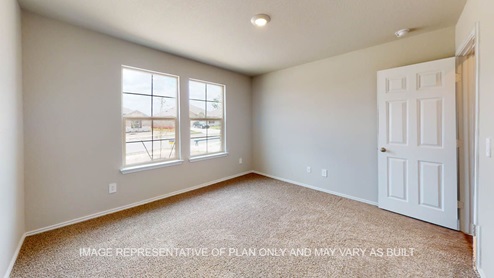 Elgin secondary bedroom with carpet flooring and window.