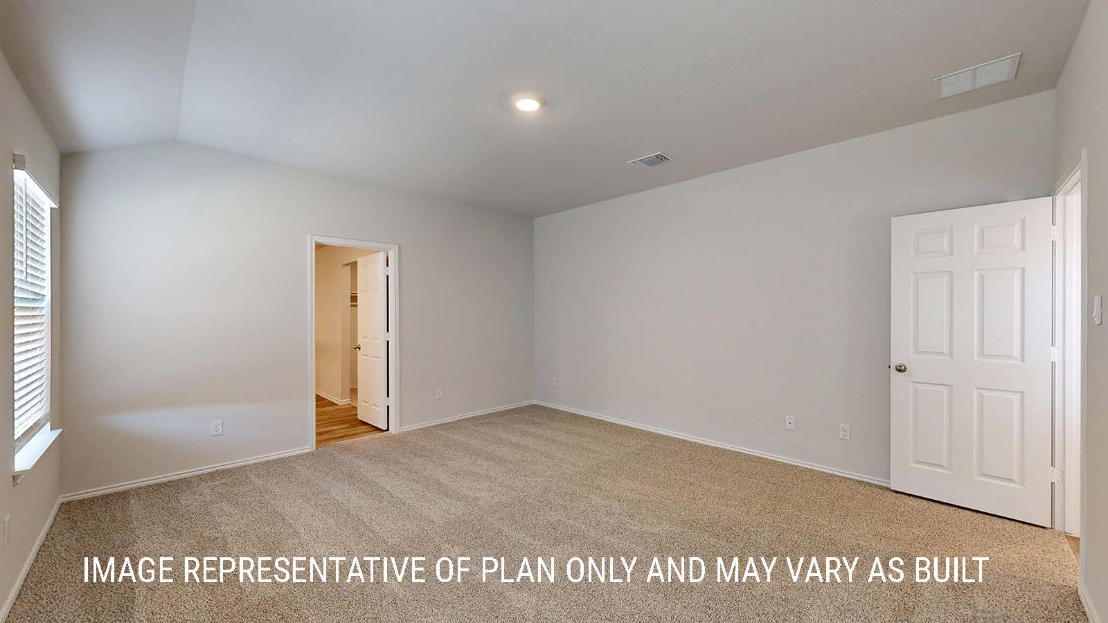 Seabrook primary bedroom with carpeted flooring and view of primary bathroom.