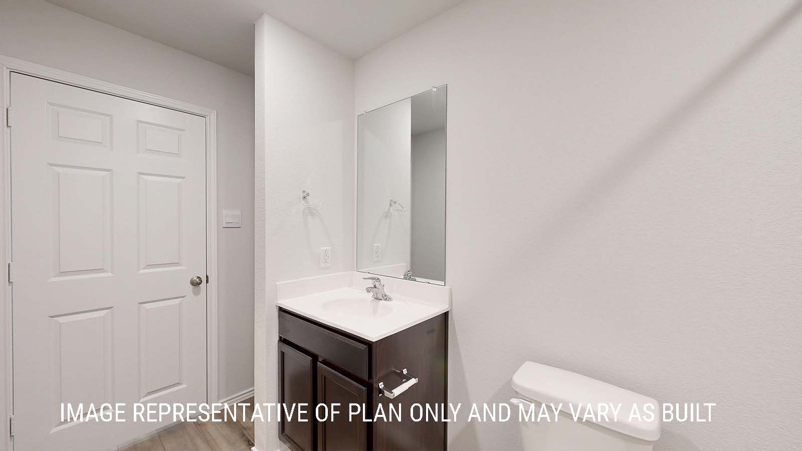 Seabrook secondary bathroom single vanity sink with dark cabinets and granite countertops.