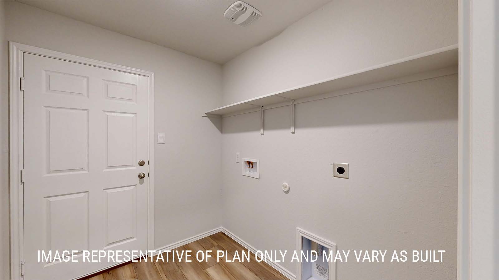 Seabrook utility room with washer and dryer connections and shelving for storage.