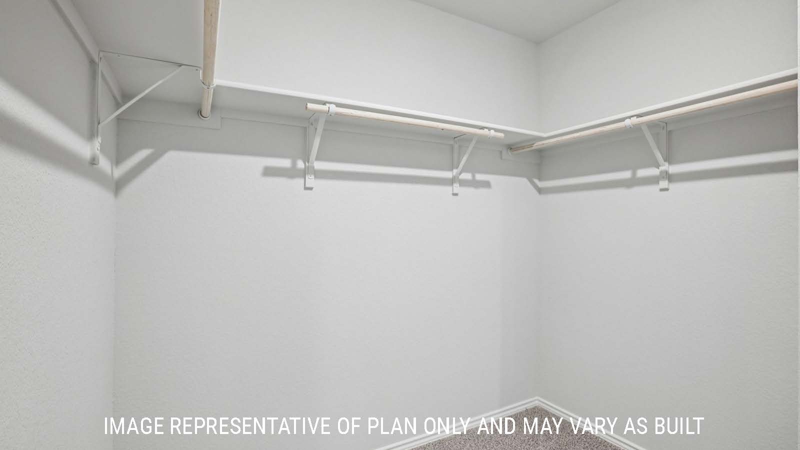 Atlanta primary bedroom closet with carpeted flooring and shelving for storage.