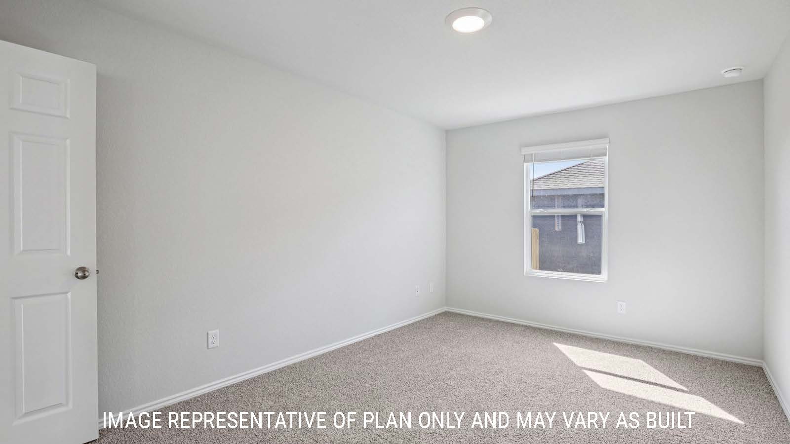 Atlanta primary bedroom with carpeted flooring and window for natural lighting.