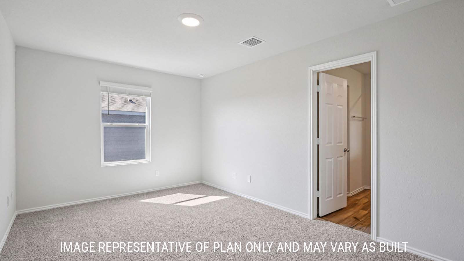 Atlanta primary bedroom with carpeted flooring and view of primary bathroom.