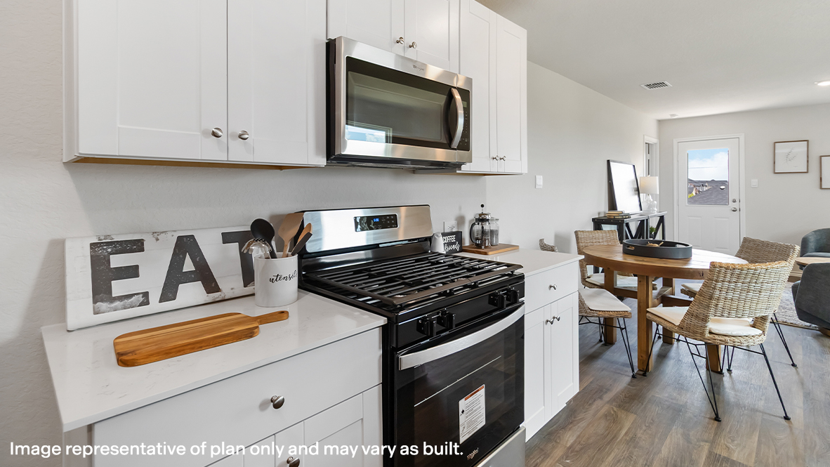 Atlanta kitchen with white cabinets and view of dining room.