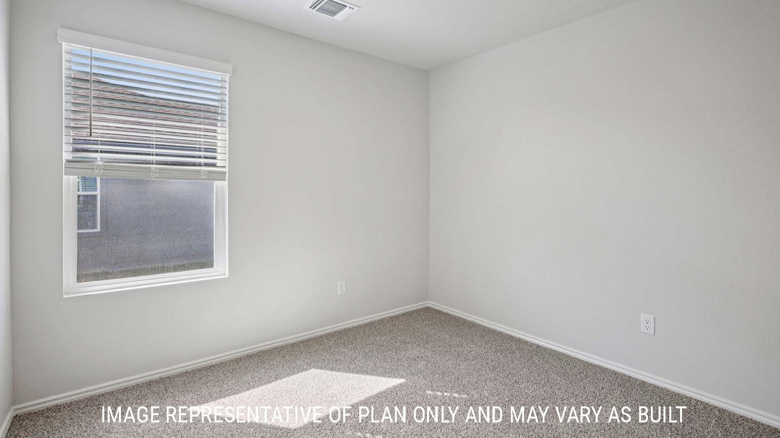 Atlanta secondary bedroom with carpeted flooring and window for lighting.