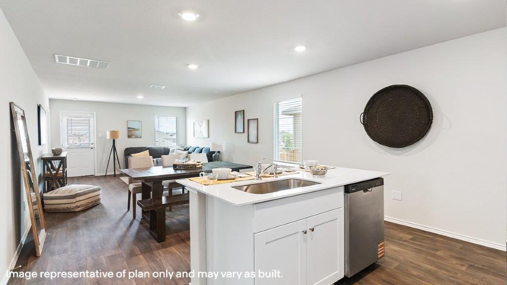 Barton kitchen with center kitchen island and view of dining room and living room.