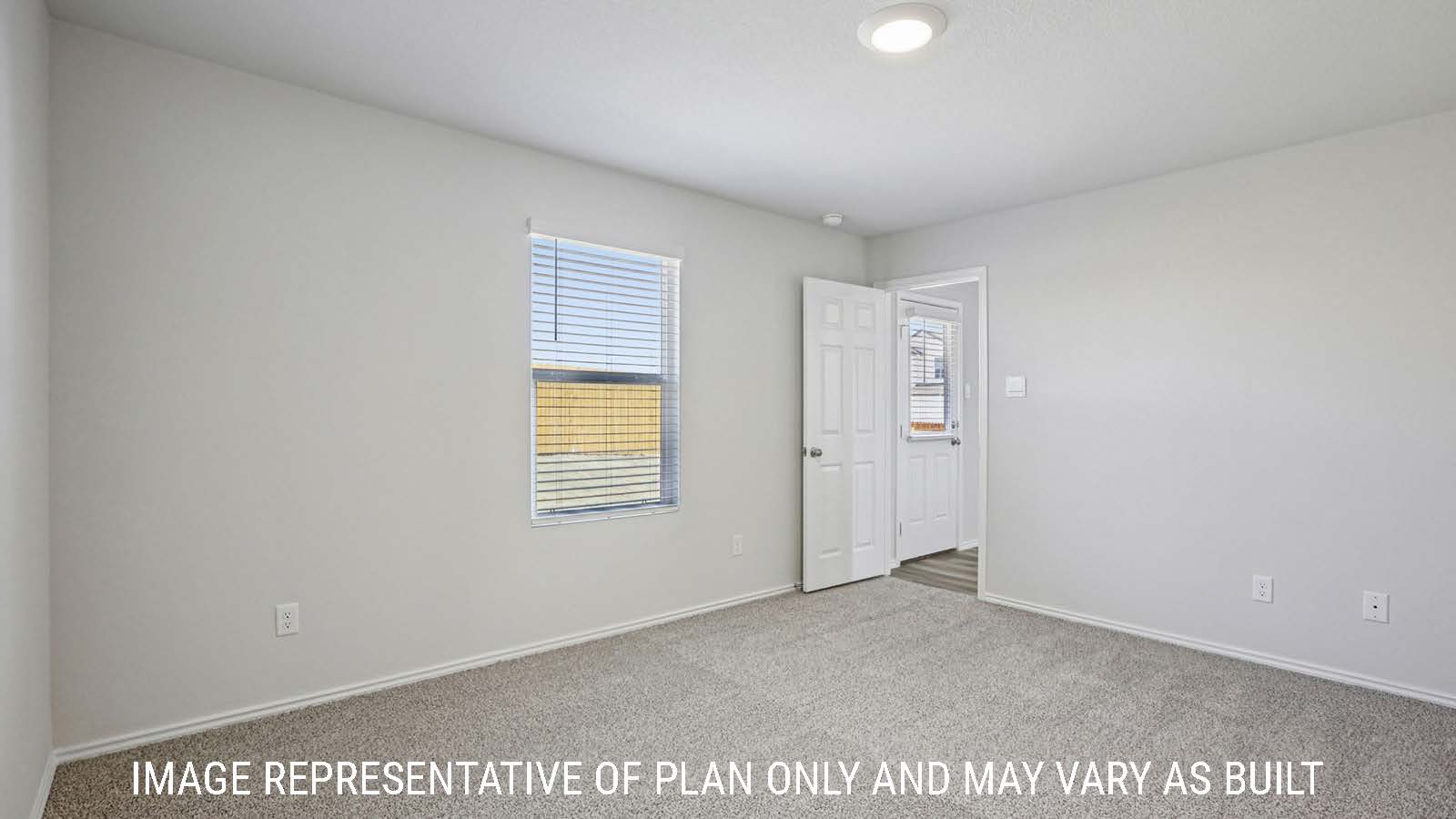 Caprock primary bedroom with carpeted flooring and window for natural lighting.
