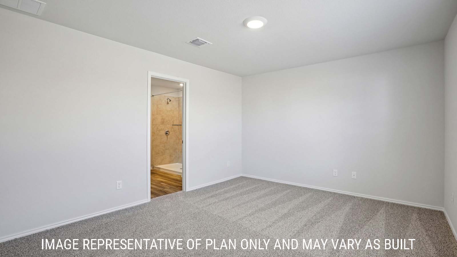 Caprock primary bedroom with carpeted flooring and view of primary bathroom.