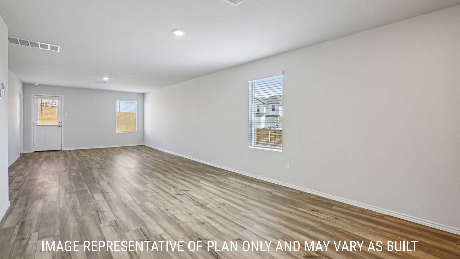 Caprock dining room with vinyl plank flooring and view of open concept living room.