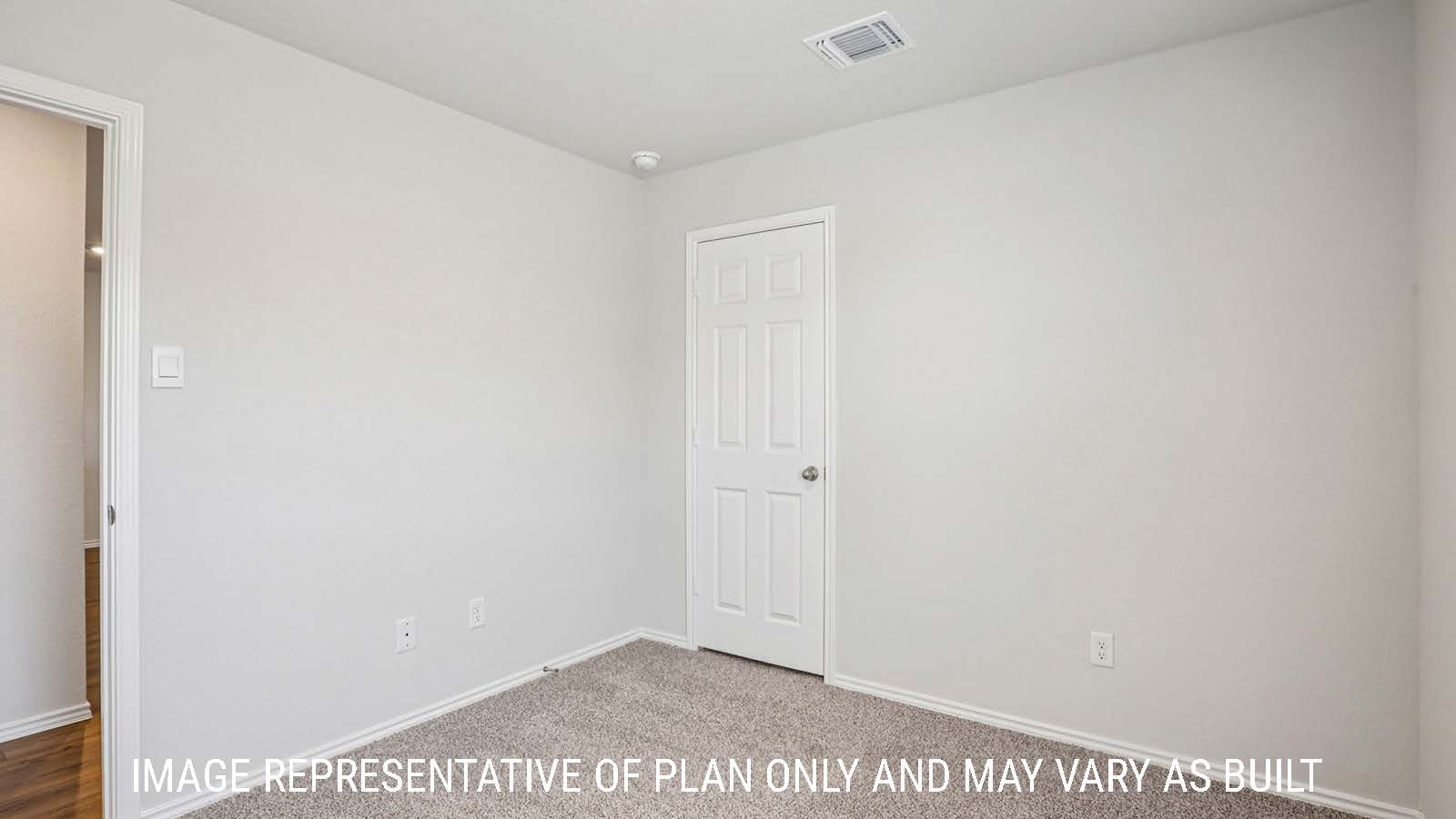 Estero secondary bedroom with carpeted flooring and view of hallway.