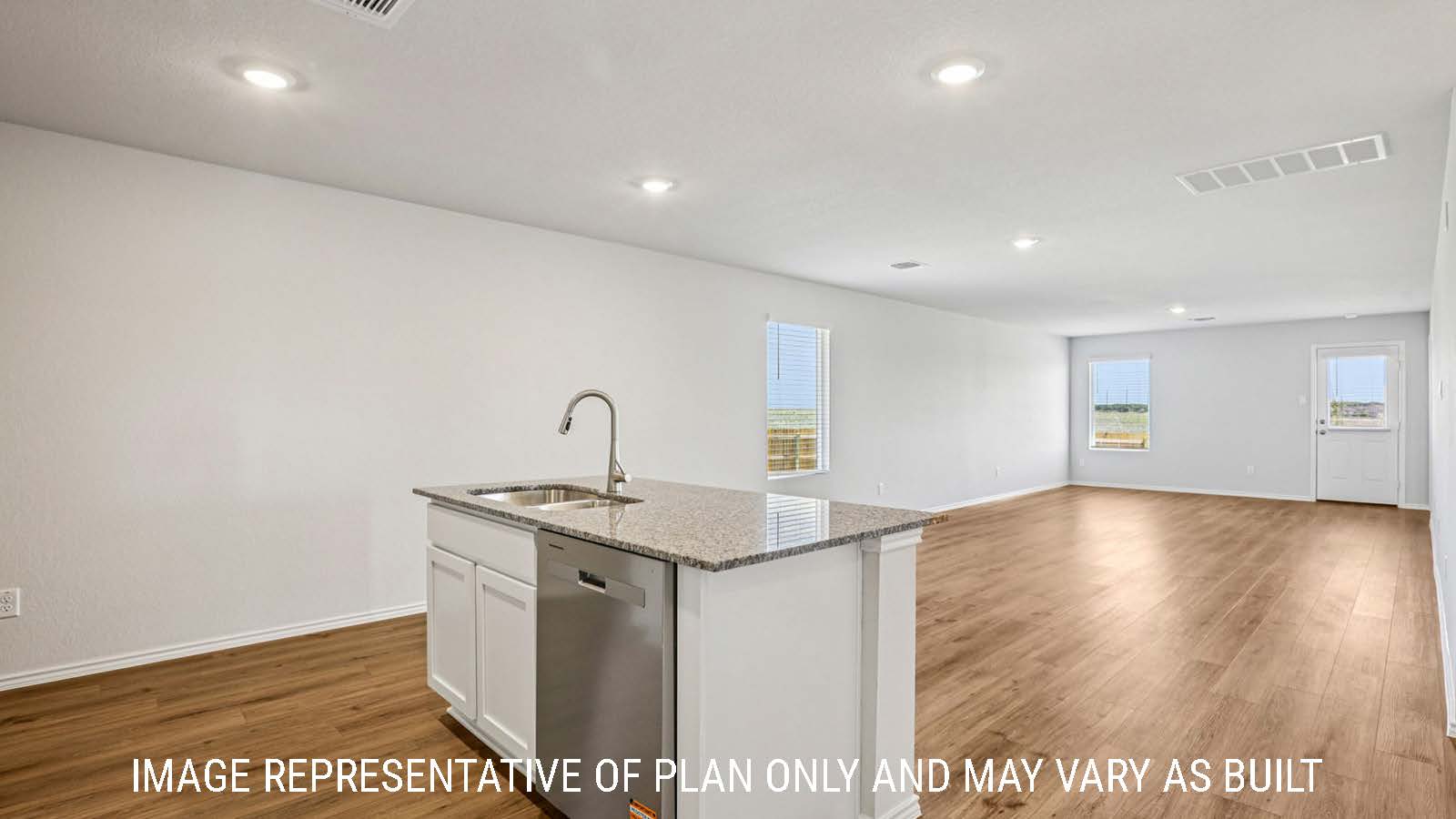 Estero kitchen with granite countertops with view of open concept dining room and living room.