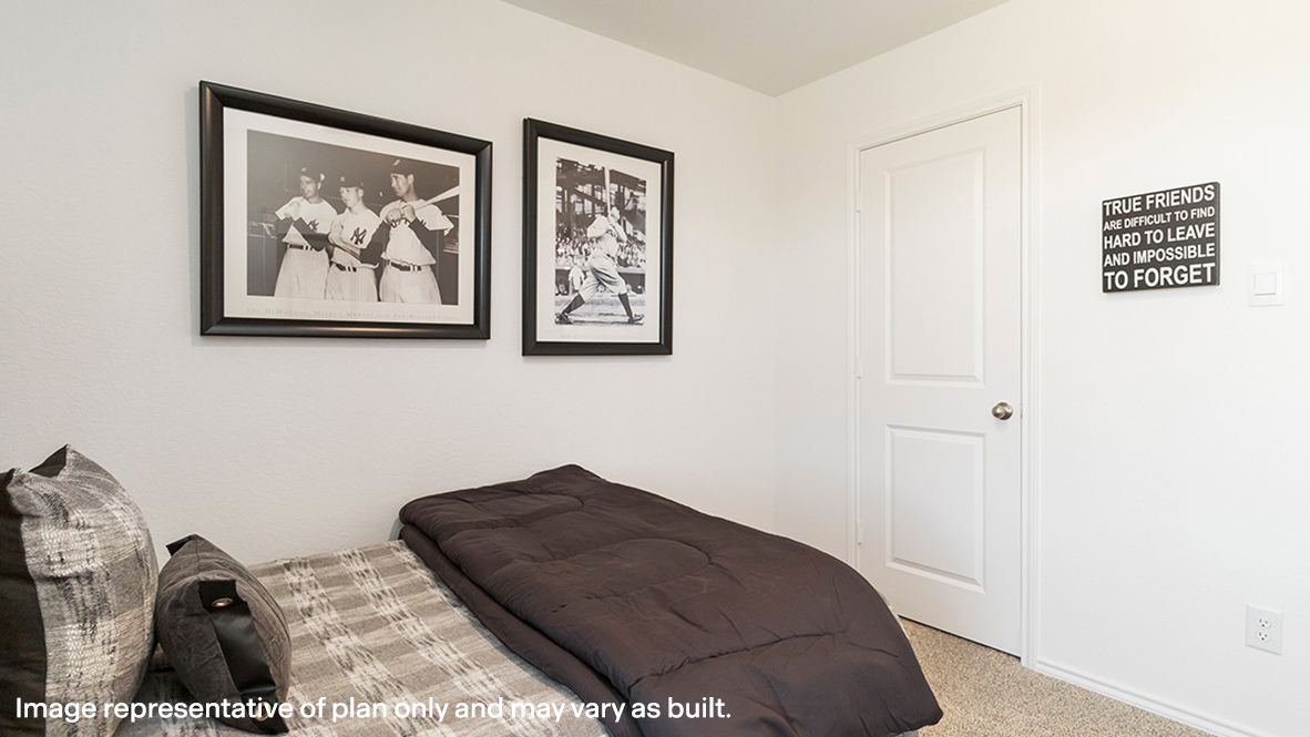 Estero secondary bedroom with carpeted flooring and closet door.