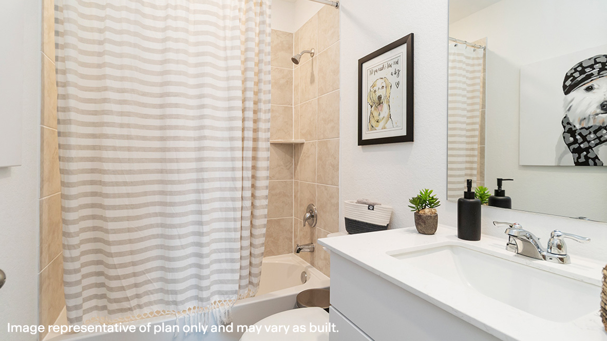 Estero secondary bathroom with single vanity and bath tub and shower combo.