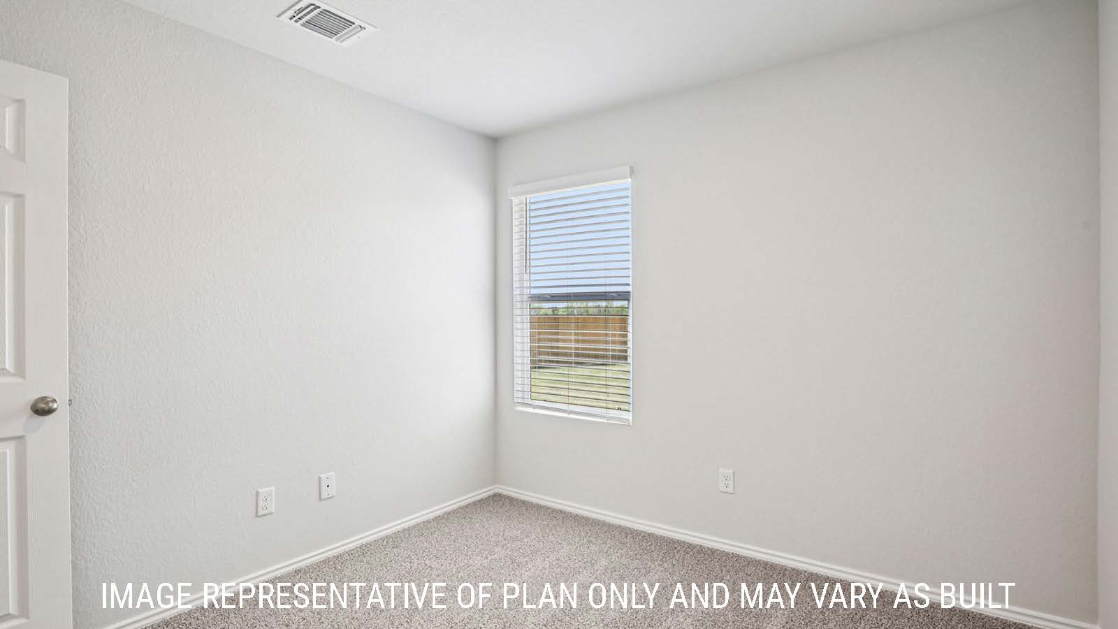 Estero secondary bedroom with carpeted flooring and window for natural lighting.