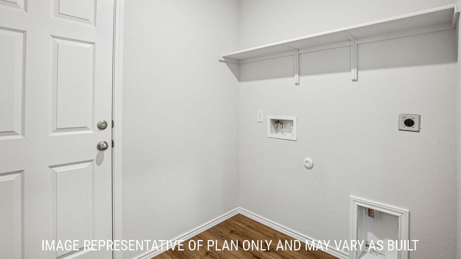 Estero utility room with washer and dryer connections and shelving for storage.