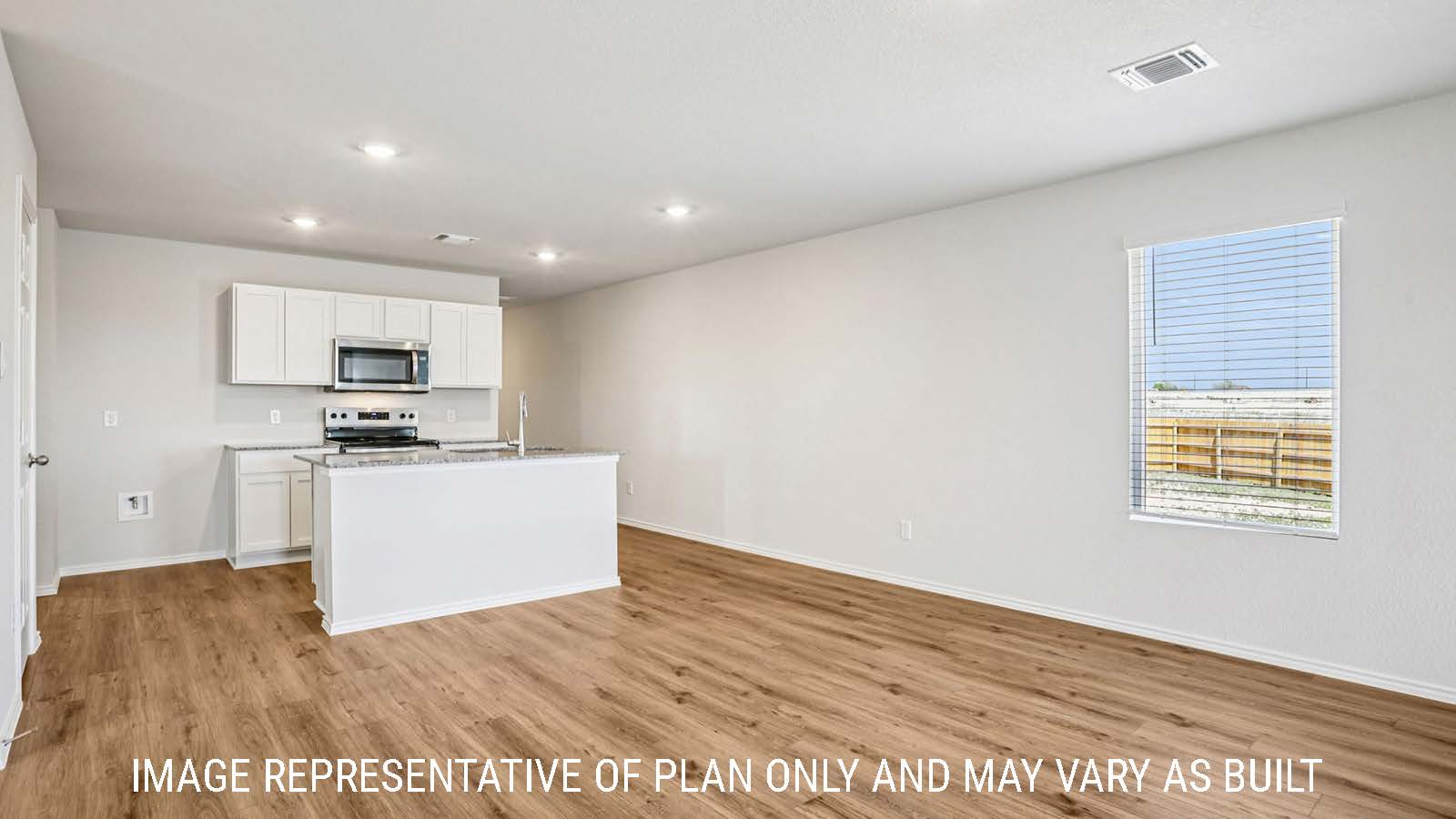 Estero dining room with vinyl plank flooring and view of open concept kitchen.