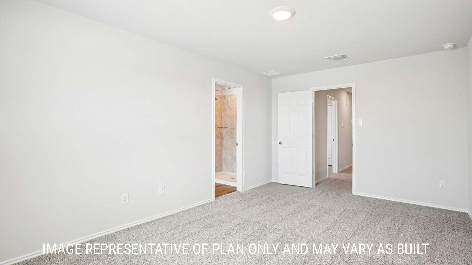 Franklin primary bedroom with carpeted flooring and view of primary bathroom.