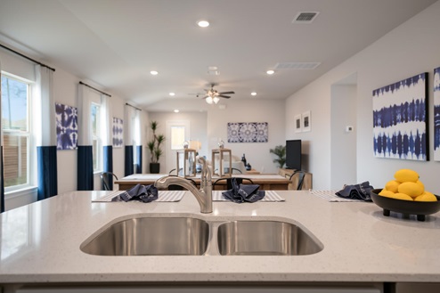 Willow Glenn model home kitchen sink with view of dining and living room.