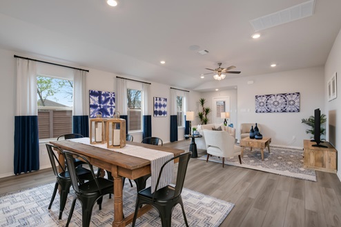 Willow Glenn model home dining room with table and view of living room.