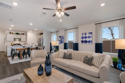 Willow Glenn model home living room with open concept of the dining room and kitchen.