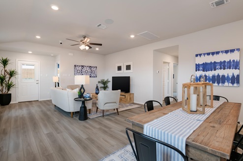 Willow Glenn model home dining room with table and view of living room.