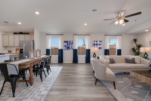 Willow Glenn model home living room with open concept of the dining room and kitchen.