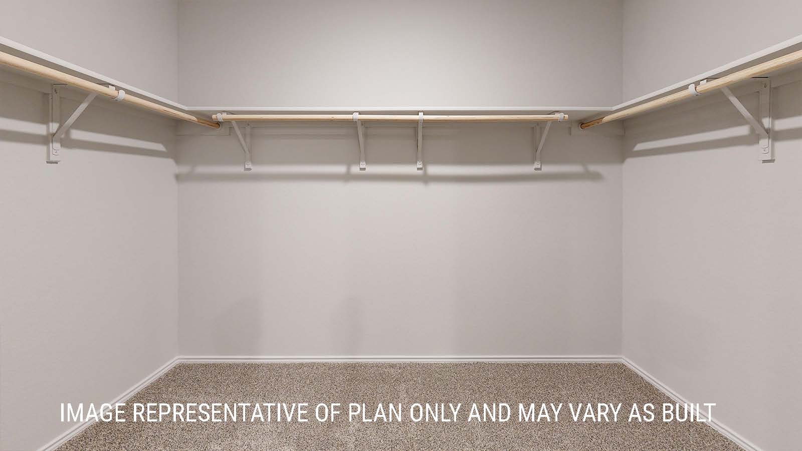 Seabrook primary walk-in closet with carpeted flooring and shelving for storage.