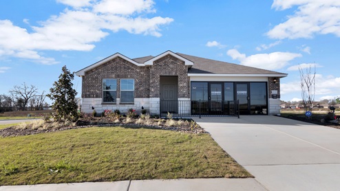 Pecan Creek model home exterior elevation with glass store front windows.