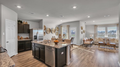 Pecan Creek model home kitchen entry with a view of living and dining room.